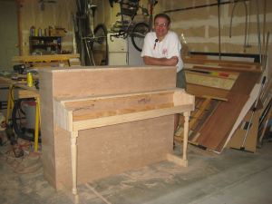 KellieAnn's Dad, Mark, stands proudly next to the stage piano his is in the process of building. 